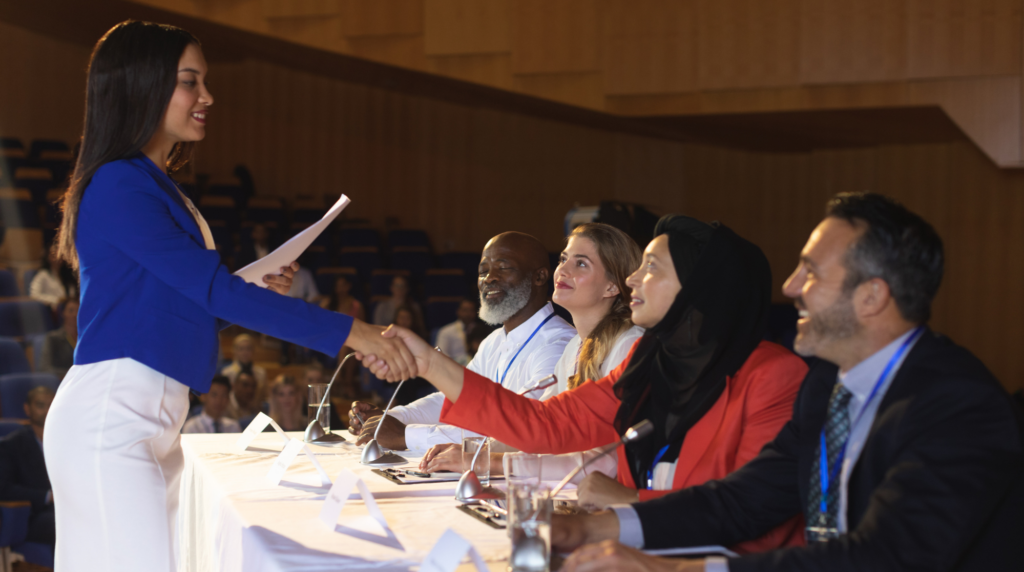 Scholarship student shaking hands with foundation members